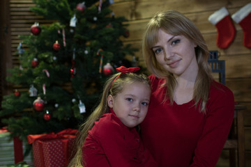Fototapeta na wymiar Mom and daughter meet a happy Christmas