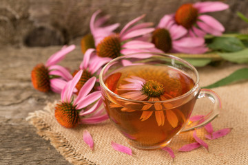 Cup of echinacea tea on old wooden table