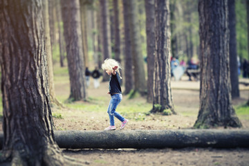 balancing on tree trunk