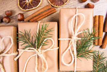 Christmas gifts in rustic boxes on wooden background.