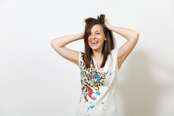 Fototapeta premium Beautiful European young funny and cheerful brown-haired woman with healthy clean skin, dressed in casual light clothes is fooling around at camera, on a white background. Emotions concept.