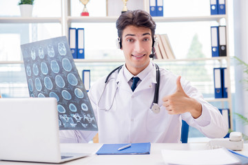 Young male doctor in telehealth concept