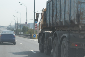 Dirty truck on a country road and cloudy sky