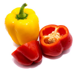 Group of peppers, cut red pepper and whole yellow isolated on white background.