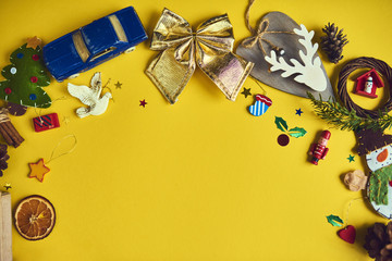A lot of Christmas decorations and toys  on yellow background. Space for text. Design mockup