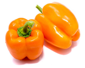 Group of orange peppers, one pepper on back, isolated on white background.