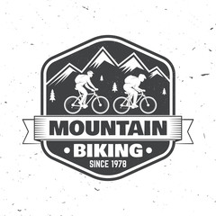 Vintage typography design with man riding bike and mountain silhouette.