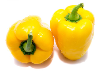 Group of yellow peppers on back, isolated on white background.