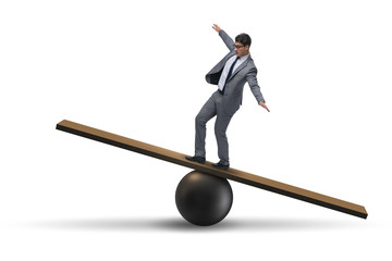 Businessman balancing on seesaw in uncertainty concept