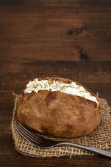 closeup sour cream and chive baked potato