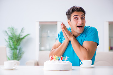 Young man celebrating birthday alone at home