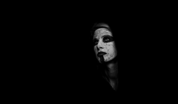 Portrait of a girl in a mystical makeover. The concept of black color. Black and white photography
