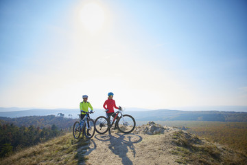 On the mountain. Two cyclist woman enjoying the beautiful scenery while out mountain biking.