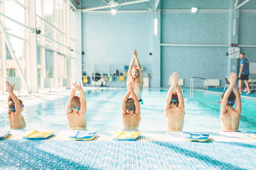 Kids doing exercise in swimming pool