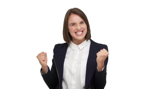 portrait of happy female office worker being glad satisfied to reach goals clenching fists feeling like winner or successful businesswoman over white background. Concept of emotions
