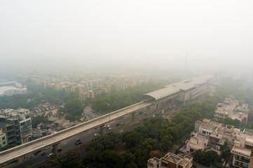Smog over a metro station passing along a major road going through homes, offices and colonys. The poor air quality has been a concern in Delhi NCR