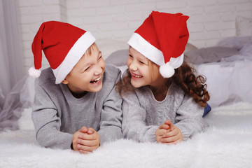 Happy kids in Santa hats paddle laugh