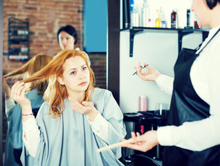 Young woman is not happy with her hair