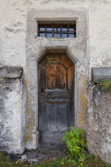 Fototapeta na wymiar The old wooden door of the church. Rear entrance.