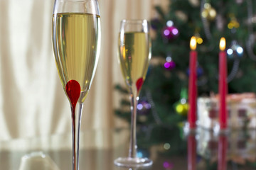 wineglass with champagne, Christmas spruce, gifts and candles