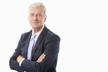 Executive senior businessman standing against white background. 