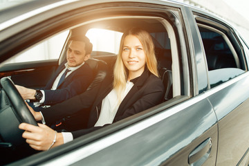Driving School - woman steer car with steering wheel, maybe she has driving test