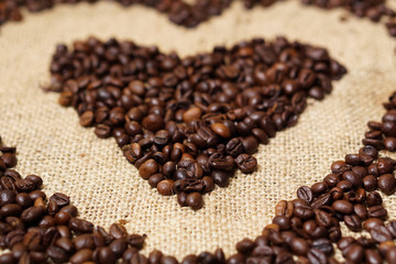 Love heart made of coffee beans on sackcloth