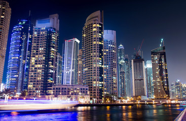 Fototapeta na wymiar Dubai marina with skyscrapers and calm water night view