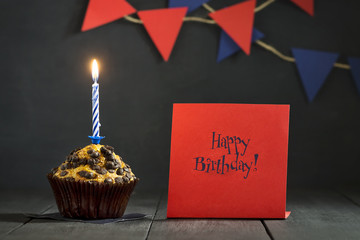 Birthday cupcake on a dark background. Happy Birthday. Postcard. Congratulations.