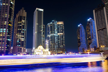 Dubai marina mosque with skyscrapers and light trails