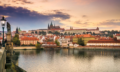 Fototapeta premium Prague Castle and Charles Bridge at sunset, Prague, Czech Republic in the fall. Lanterns and sculptures on the Charles Bridge