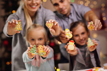 Happy family preparing Christmas biscuits
