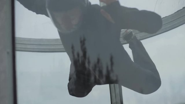 Man skydiver flying in wind tunnel. Training jumping indoor skydiving tunnel