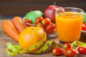 Healthy concept with mixed fruits and vegetables on wooden background