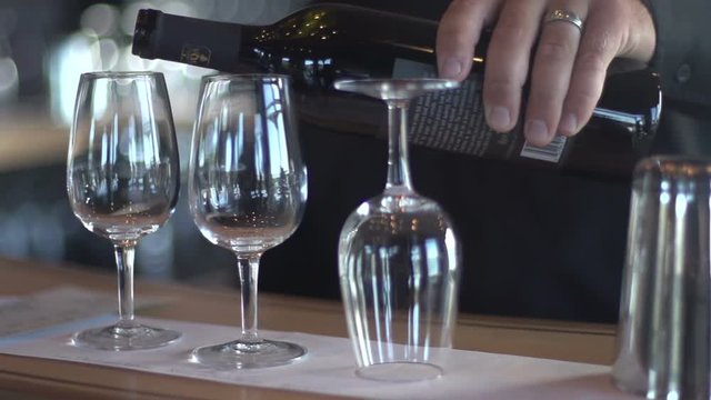 A slowmo shot of red wine being poured into a glass