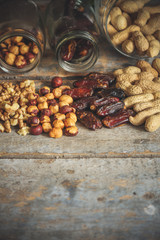nut assortment and dates on a wooden surface