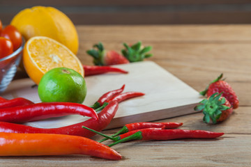 Healthy concept with mixed fruits and vegetables on wooden background