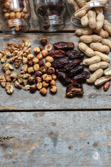 nut assortment and dates on a wooden surface