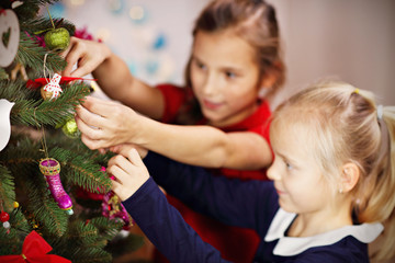 Children decorating Christmas tree