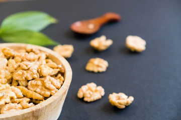 Whole Walnuts and Cleared Black Wooden Background Top view Healthy concept. Natural light. Selective focus. Close up on a black background. Top view, flat lay. copy space.