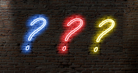 neon light question marks on a dark brick wall