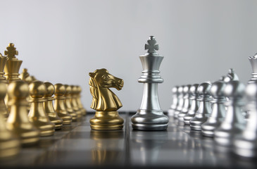 Chess (knight confront king and opponent) on white background. Strategy, market share, business investment, business competition, opportunity, brave, fearless, dare, challenge or front line concept. © Costello77