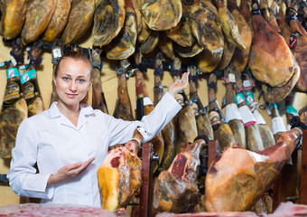 Woman  wearing uniform showing iberian ham