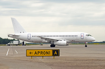 Fototapeta na wymiar White passenger airplane taxiing at the airport.
