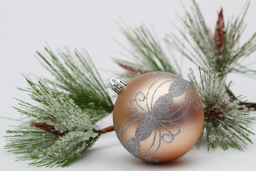 Cream and silver color Christmas bauble and pine
