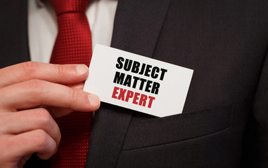 Businessman putting a card with text SUBJECT MATTER EXPERT in the pocket