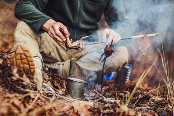 Fototapeta premium quail on the stick grilled in the fire. delicious forest picnic. bushcraft concept