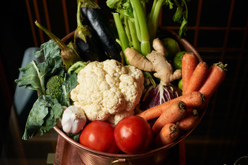 Fresh organic vegetables in wooden bowl