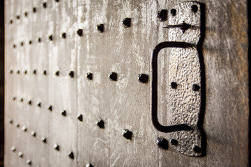 Heavy old wooden castle door with studs. Soft focus and backlit. Stirling Castle, Scotland