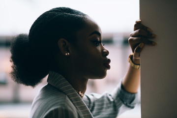 Close up profile portrait of serene portrait of young adult african-american woman's face.